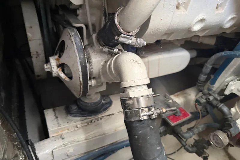 Slide: The Image of Engine compartment of a 2000 Cabo 35 Flybridge boat, showing mechanical components and hoses. - 99