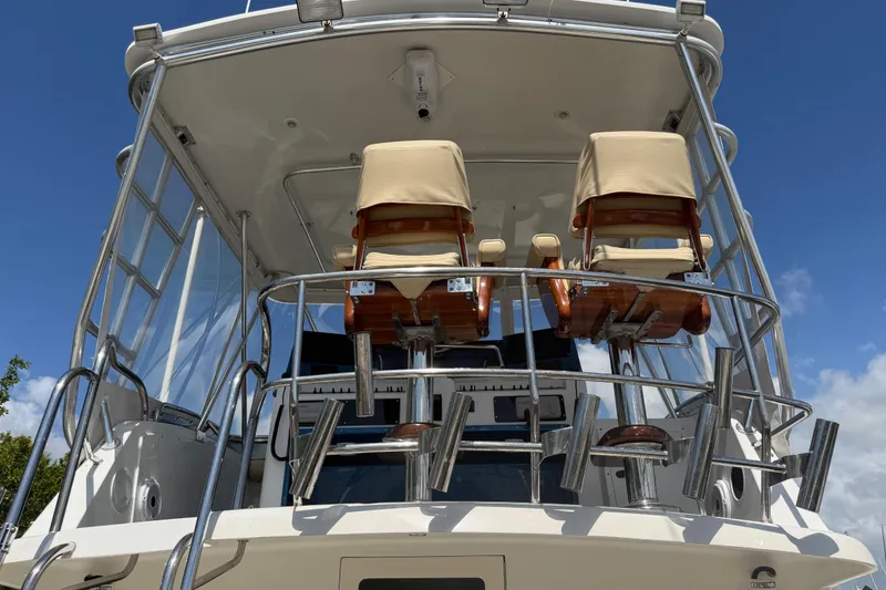 Slide: The Image of Cabo 35 Flybridge 2000 model with dual helm chairs and stainless steel railings. - 49