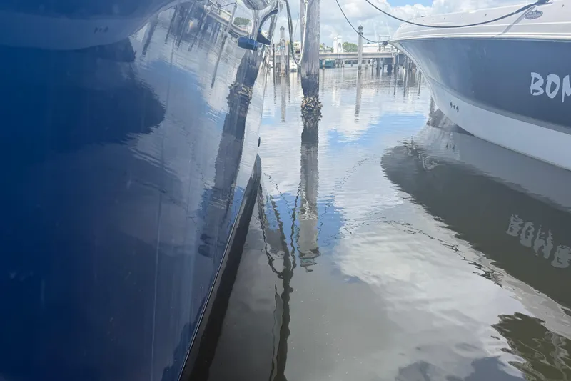 Slide: The Image of Cabo 35 Flybridge 2000 model docked, reflecting on calm marina waters. - 22