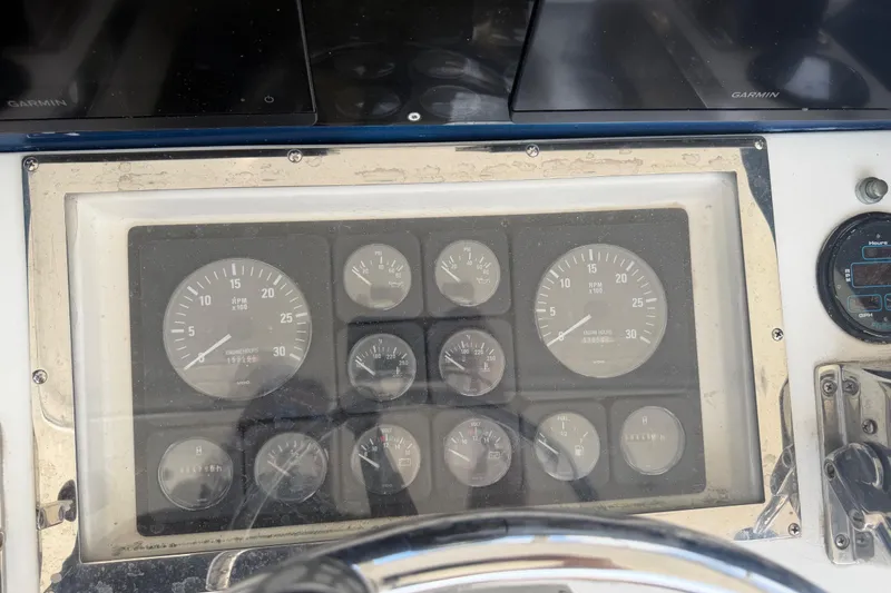 Slide: The Image of Instrument panel of a 2000 Cabo 35 Flybridge boat with various gauges and displays. - 12