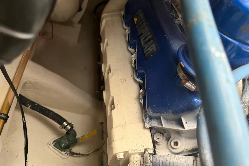 Slide: The Image of Engine compartment of a 2000 Cabo 35 Flybridge boat, featuring a Caterpillar engine. - 104