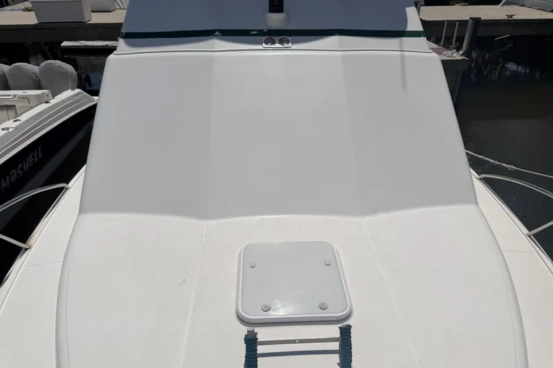 Slide: The Image of Cabo 35 Flybridge 2000 boat deck with hatch, docked at marina. - 43
