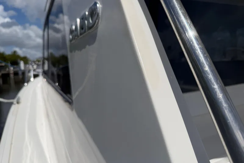 Slide: The Image of Close-up of 2000 Cabo 35 Flybridge yacht exterior with chrome railing and logo. - 31