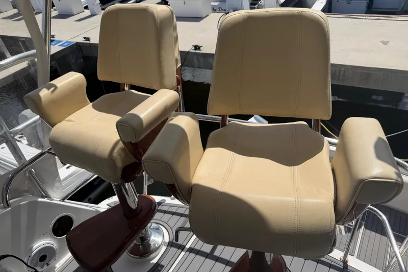 Slide: The Image of Two beige captain chairs on a 2000 Cabo 35 Flybridge boat deck. - 8