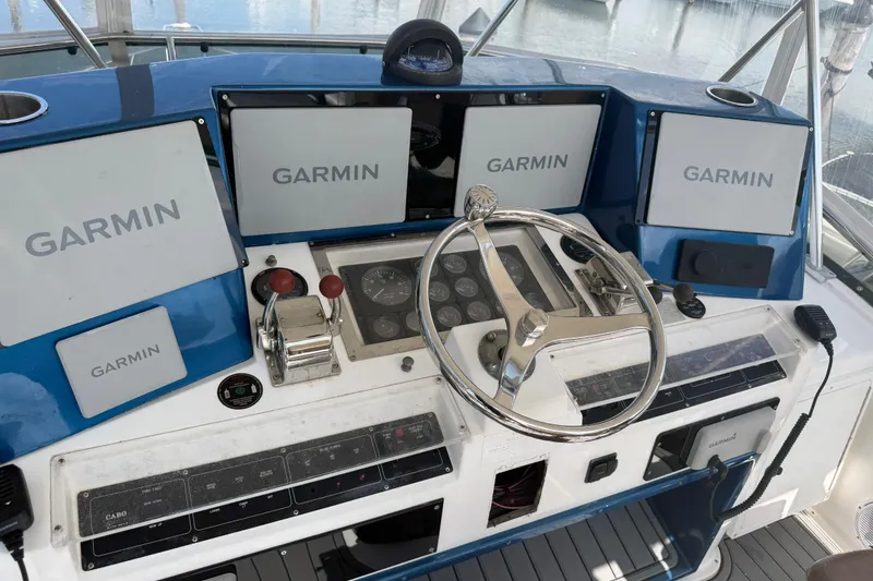 Slide: The Image of Helm of 2000 Cabo 35 Flybridge with Garmin navigation displays and controls. - 10