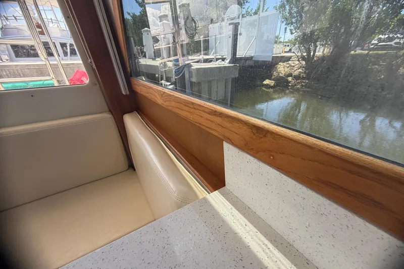 Slide: The Image of Interior view of 2000 Cabo 35 Flybridge boat with window and seating area. - 69