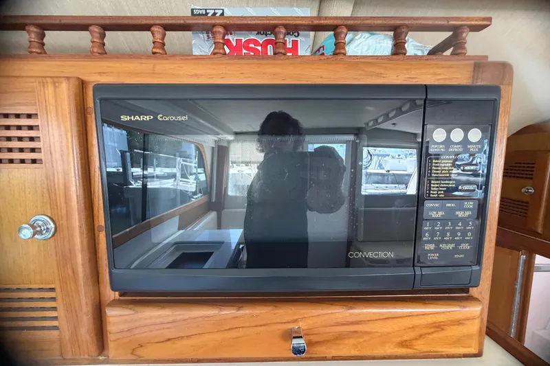 Slide: The Image of Sharp Carousel microwave in a 2000 Cabo 35 Flybridge boat interior. - 72