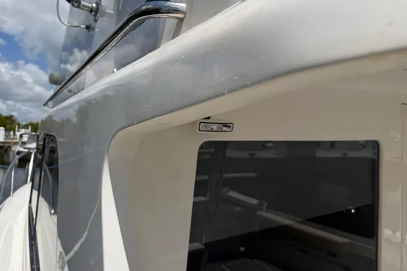 Slide: The Image of Cabo 35 Flybridge 2000 boat exterior with railing and window detail. - 29