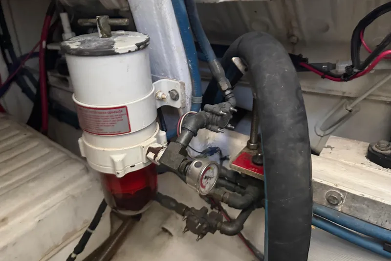 Slide: The Image of Engine compartment of 2000 Cabo 35 Flybridge with fuel filter and hoses. - 94