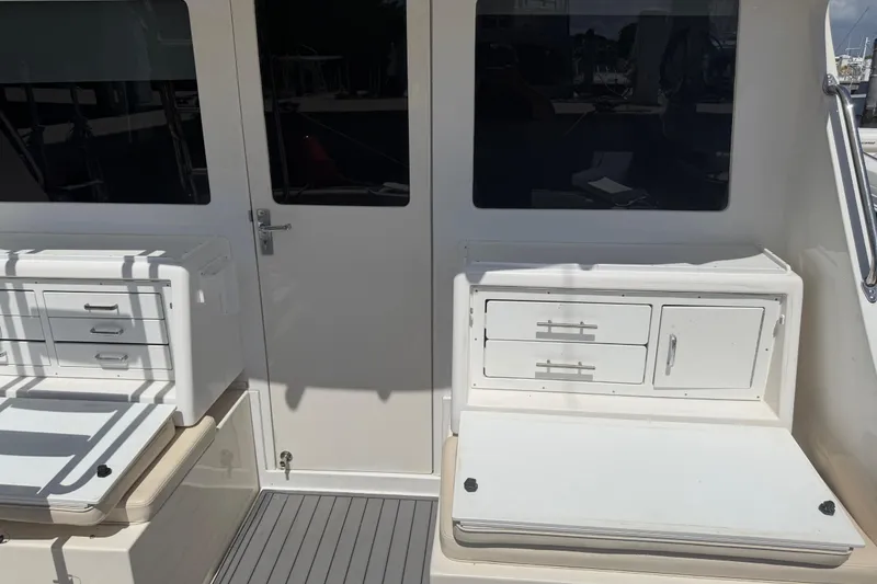 Slide: The Image of Cabo 35 Flybridge 2000 boat interior with storage compartments and seating. - 54