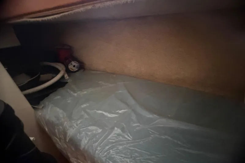 Slide: The Image of Interior cabin view of a 2000 Cabo 35 Flybridge boat with storage area. - 79