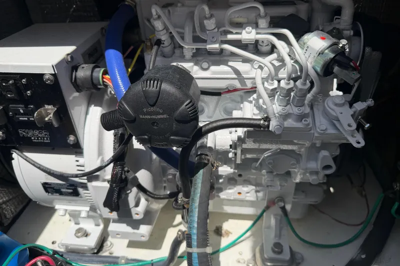 Slide: The Image of Engine compartment of a 2000 Cabo 35 Flybridge boat, featuring detailed components. - 91