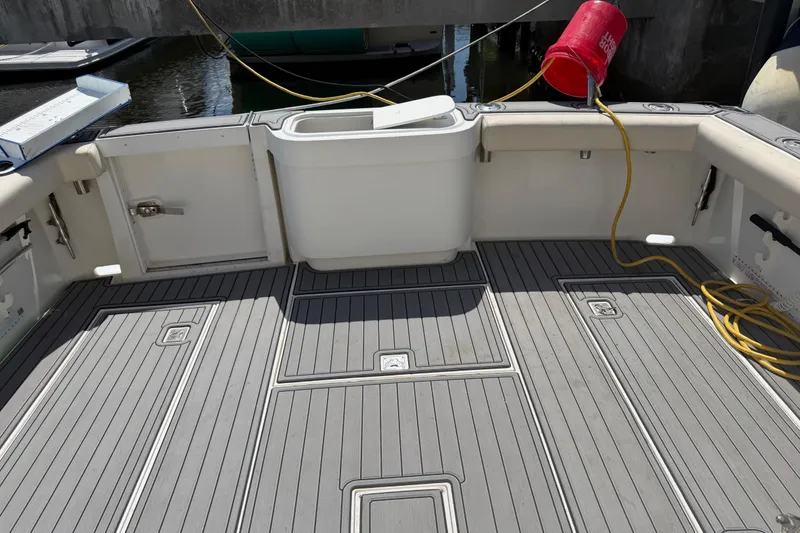Slide: The Image of Cabo 35 Flybridge 2000 boat deck with storage compartments and fishing equipment. - 44