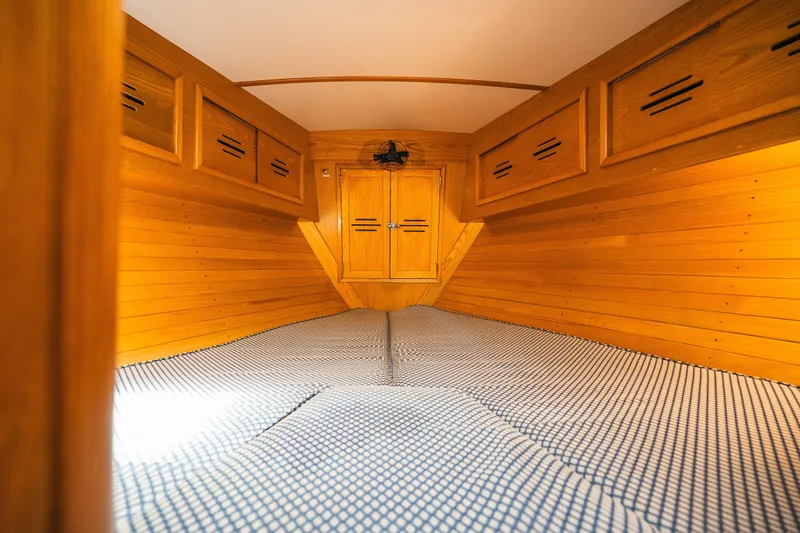 Slide: The Image of Cozy wooden cabin interior of 1985 Hinckley Sou'wester 51 sailboat, featuring built-in storage. - 25