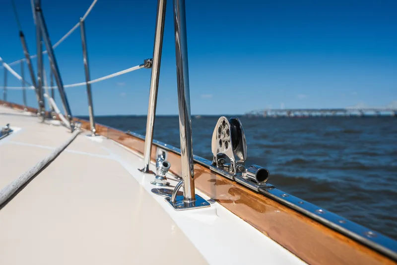 Slide: The Image of Hinckley Sou'wester 51 sailboat deck, 1985 model, cruising on open water under clear blue skies. - 50