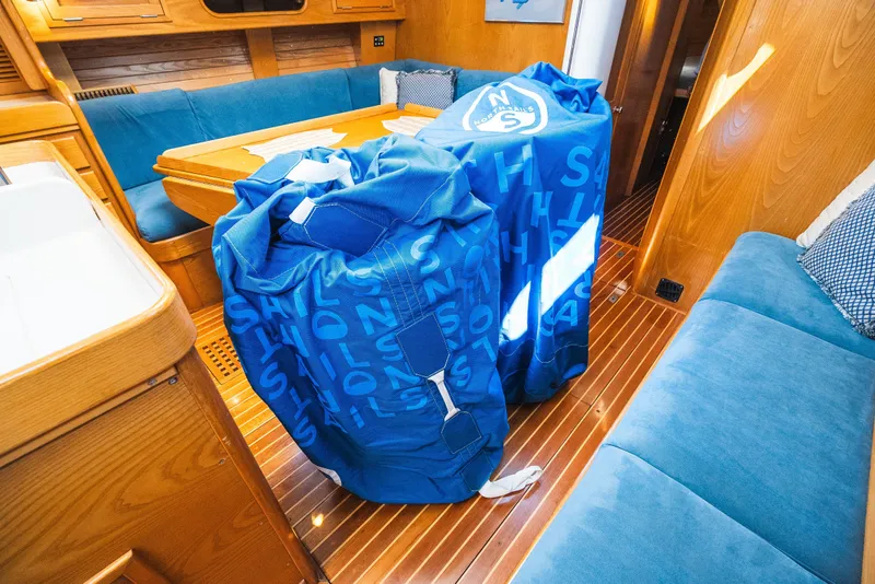 Slide: The Image of Interior of 1985 Hinckley Sou'wester 51 yacht with blue sail bags and wooden furnishings. - 33