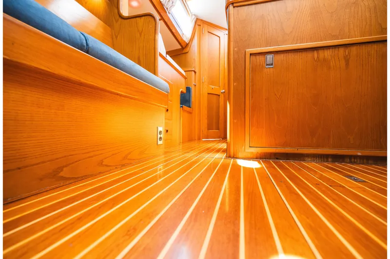 Slide: The Image of Interior of 1985 Hinckley Sou'wester 51 yacht with polished wood flooring and cabinetry. - 30