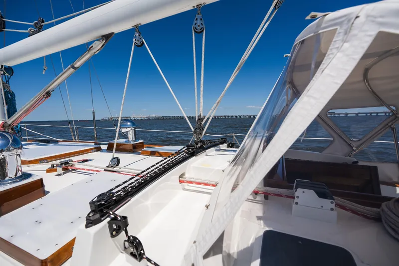 Slide: The Image of 1985 Hinckley Sou'wester 51 sailboat deck with clear skies and ocean view. - 40