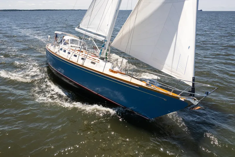 Slide: The Image of 1985 Hinckley Sou'wester 51 sailboat navigating open waters under full sail. - 1