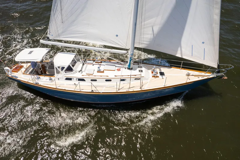 Slide: The Image of 1985 Hinckley Sou'wester 51 sailboat cruising on open water with full sails. - 4