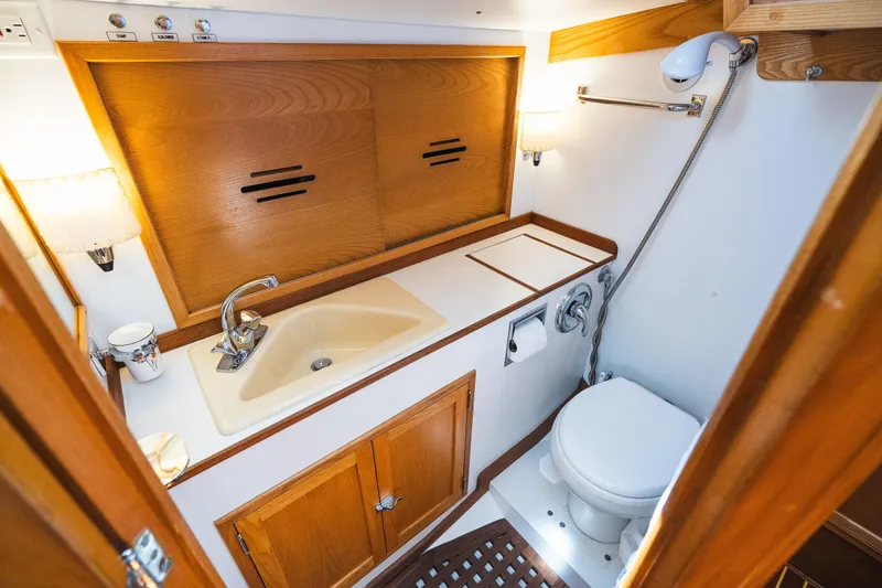 Slide: The Image of Hinckley Sou'wester 51 yacht bathroom, 1985 model, featuring wooden cabinetry and compact design. - 29
