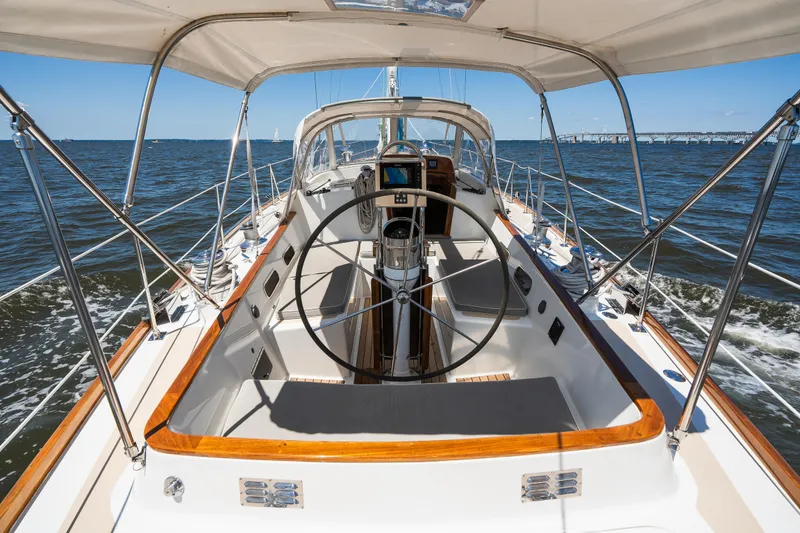 Slide: The Image of Hinckley Sou'wester 51 sailboat cockpit, 1985 model, cruising on open water under clear skies. - 38