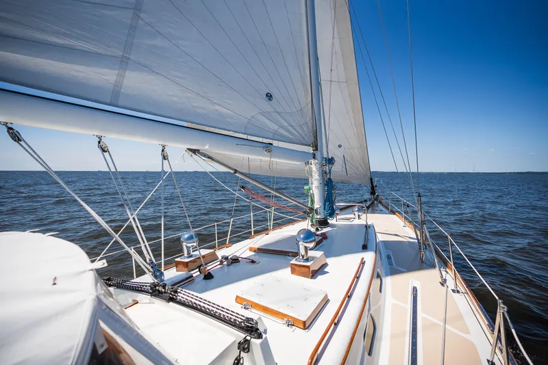 Slide: The Image of Sailing on a 1985 Hinckley Sou'wester 51 yacht under clear blue skies. - 55