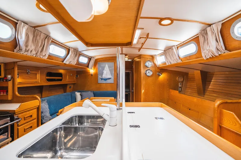 Slide: The Image of Interior of 1985 Hinckley Sou'wester 51 yacht, featuring elegant wood finishes and modern amenities. - 10