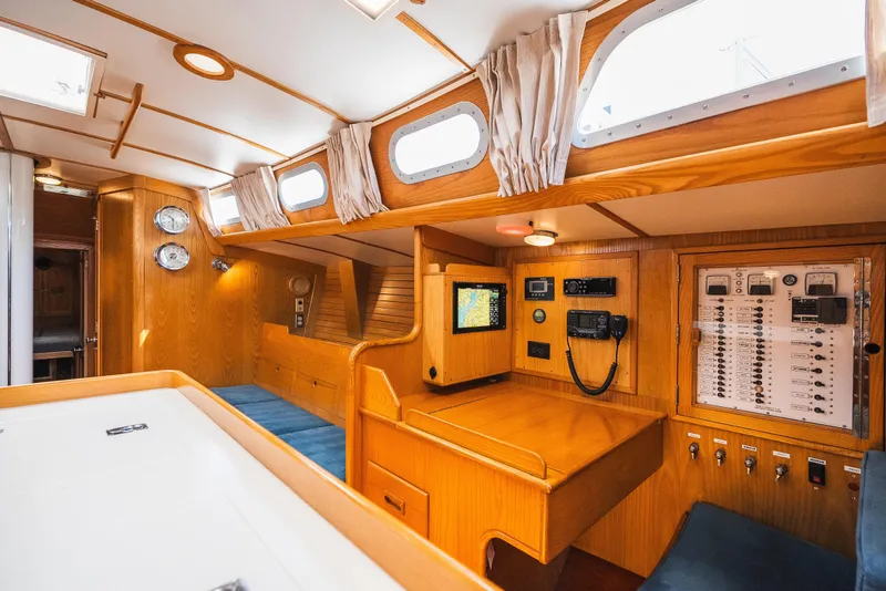 Slide: The Image of Interior of 1985 Hinckley Sou'wester 51 yacht with navigation station and wooden finish. - 14