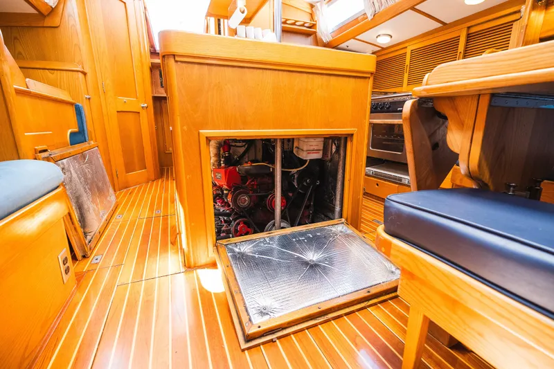Slide: The Image of Interior of 1985 Hinckley Sou'wester 51 yacht showing engine compartment and wooden flooring. - 31