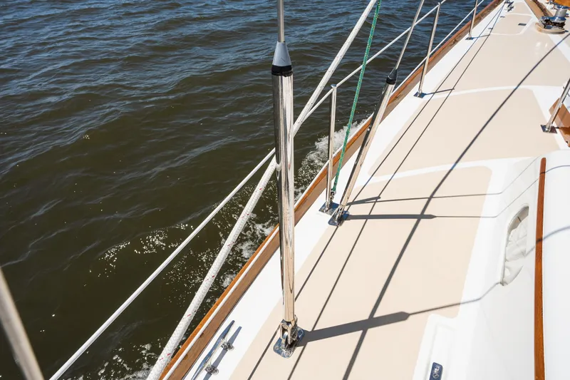 Slide: The Image of 1985 Hinckley Sou'wester 51 sailboat deck with railing, sailing on open water. - 51