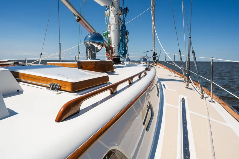 Slide: The Image of 1985 Hinckley Sou'wester 51 sailboat deck with polished wood and ocean view. - 49