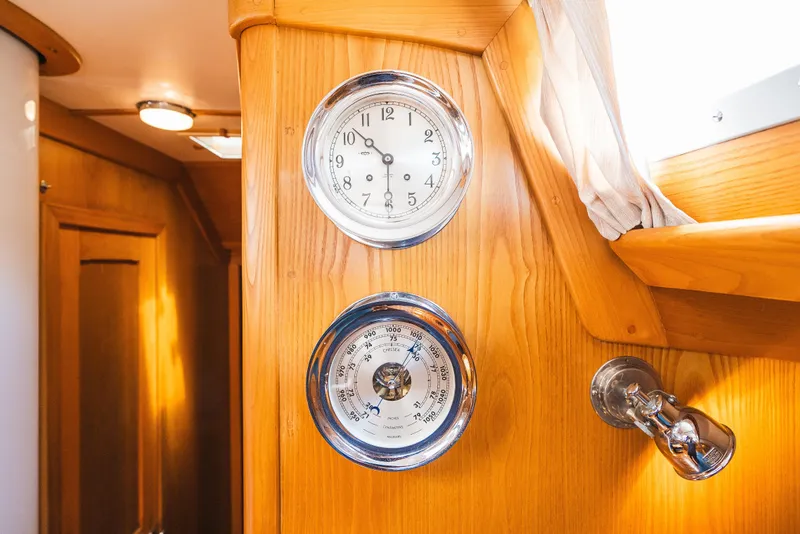 Slide: The Image of Hinckley Sou'wester 51 yacht interior with clock and barometer on wooden panel, 1985 model. - 35