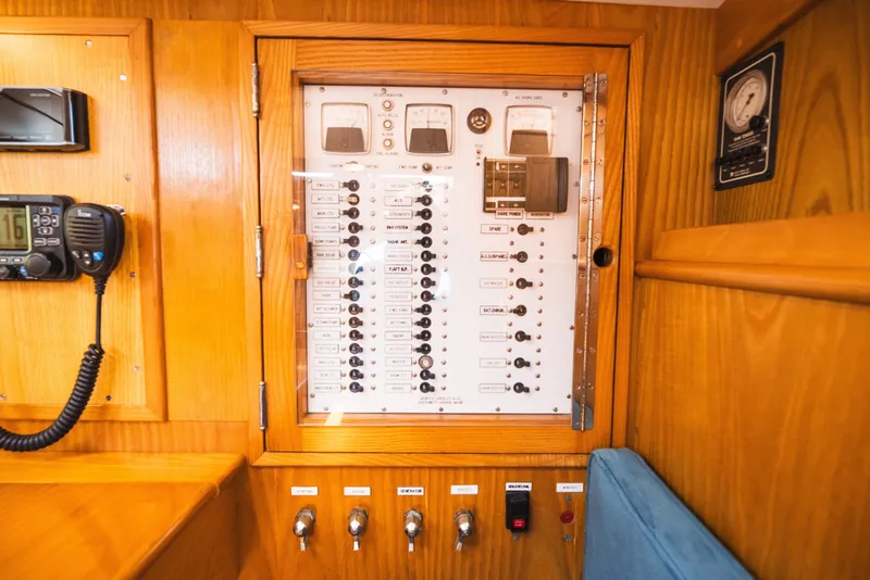 Slide: The Image of Electrical panel inside 1985 Hinckley Sou'wester 51 yacht, featuring switches and gauges. - 16