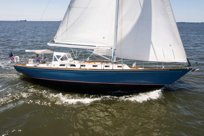 Slide: The Image of 1985 Hinckley Sou'wester 51 sailboat cruising on open water with full sails. - 3