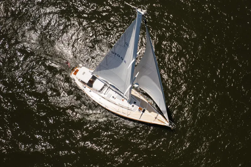 Slide: The Image of Aerial view of 1985 Hinckley Sou'wester 51 sailboat gliding on shimmering water. - 64