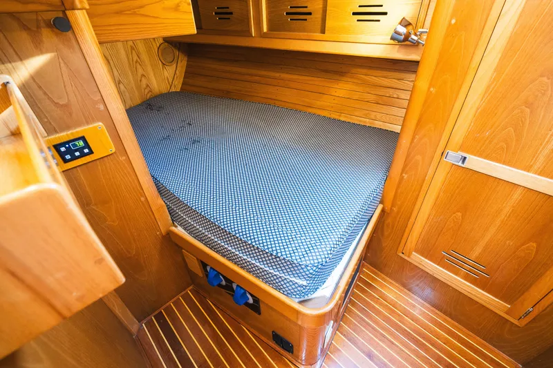 Slide: The Image of Cozy cabin interior of 1985 Hinckley Sou'wester 51 sailboat with wooden finish. - 27