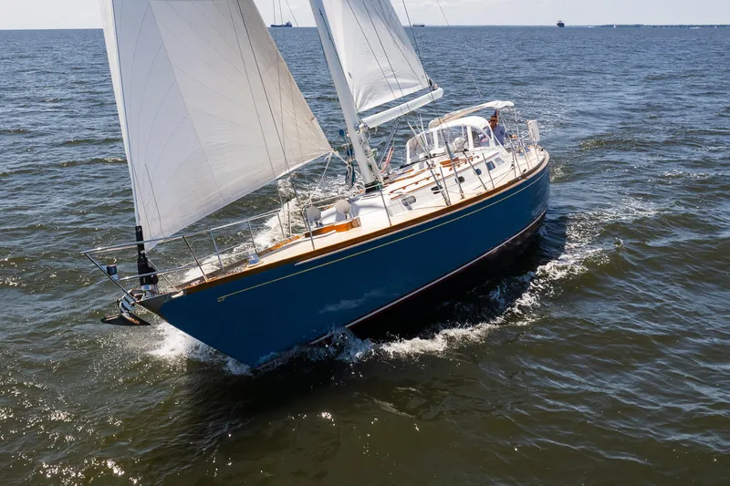Slide: The Image of 1985 Hinckley Sou'wester 51 sailing on open water with full sails. - 2