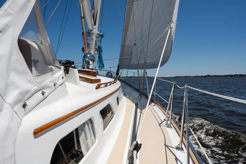 Slide: The Image of Sailing on a 1985 Hinckley Sou'wester 51 yacht under clear blue skies. - 58