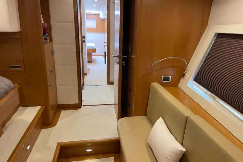 Slide: The Image of Luxurious interior of 2018 Serenity 64 yacht, featuring elegant wood finishes and cozy seating. - 38