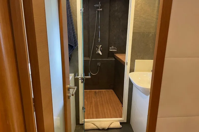 Slide: The Image of Modern bathroom with wooden accents in a 2018 Serenity 64 yacht. - 35