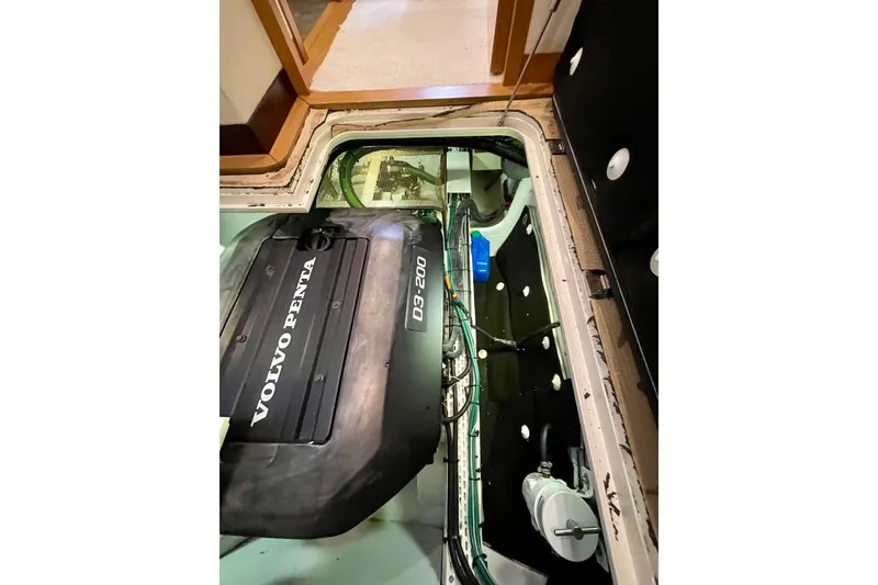 Slide: The Image of Engine compartment of a 2018 Serenity 64 yacht featuring a Volvo Penta D3-200 engine. - 67
