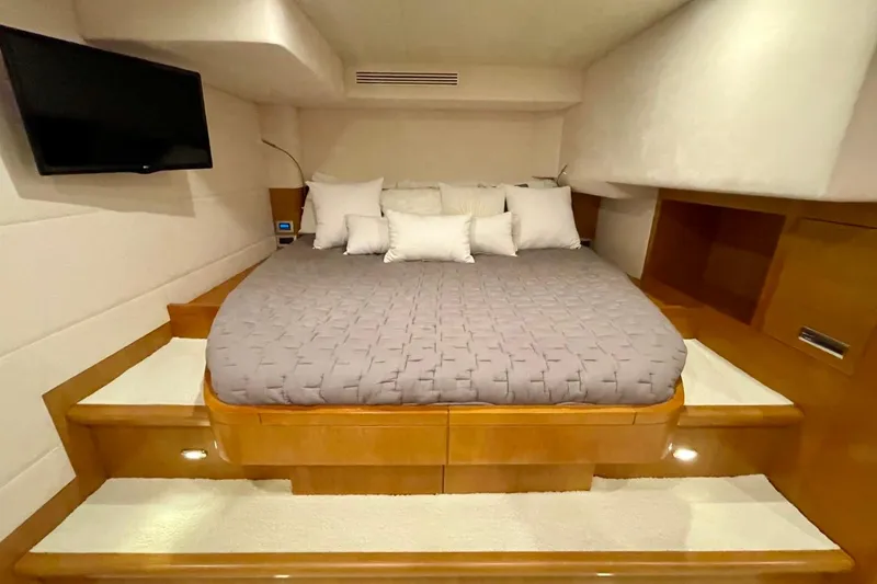 Slide: The Image of Luxurious bedroom interior of 2018 Serenity 64 yacht with cozy bedding and mounted TV. - 45