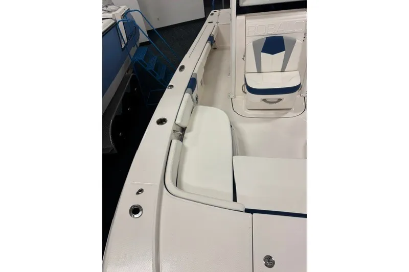 Slide: The Image of 2026 Robalo 246 Cayman boat interior with white and blue seating. - 9