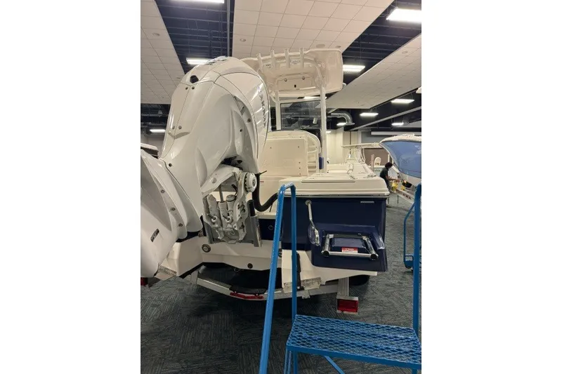 Slide: The Image of 2026 Robalo 246 Cayman boat displayed indoors, showcasing its powerful outboard motor. - 3