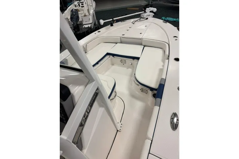 Slide: The Image of 2026 Robalo 246 Cayman boat interior with white seating and blue accents. - 6
