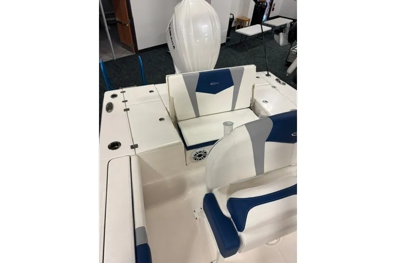 Slide: The Image of 2026 Robalo 246 Cayman boat interior with blue and white seating and Yamaha engine. - 7