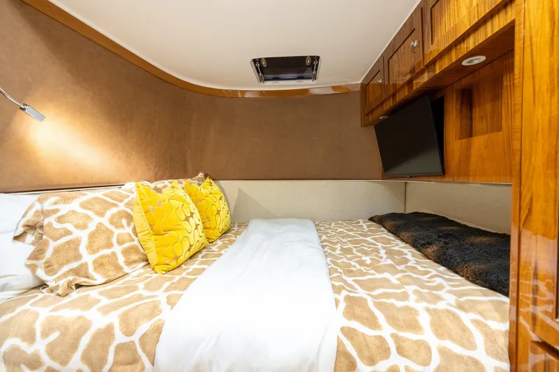 Slide: The Image of Luxurious cabin interior of 2023 HCB 65 Estrella with plush bedding and wooden cabinetry. - 31