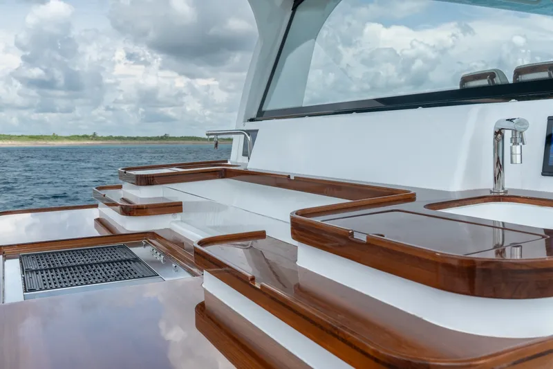 Slide: The Image of Luxurious 2023 HCB 65 Estrella yacht deck with sleek wooden finishes and ocean view. - 46