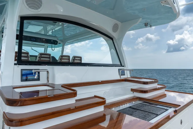 Slide: The Image of 2023 HCB 65 Estrella yacht with sleek outdoor kitchen and ocean view. - 45